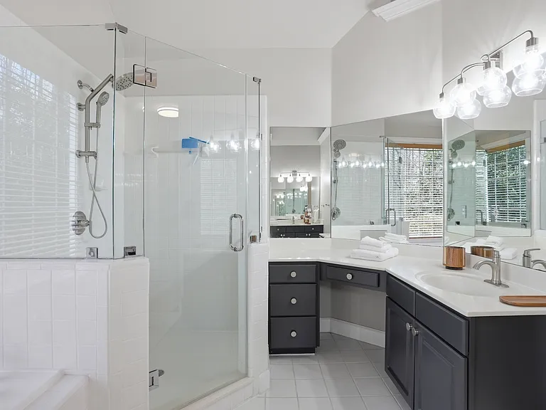 Thoughtfully updated primary bath with double vanity and modern finishes