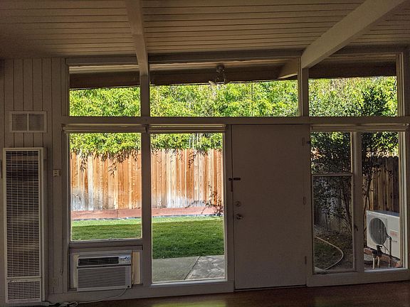 Vaulted living room ceilings with view to backyard