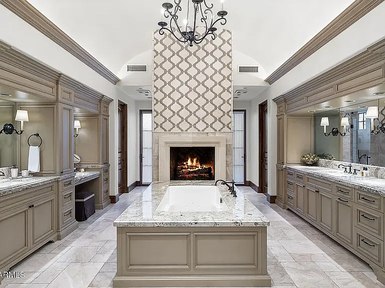 Impressive primary bath designed for relaxation, complete with a soaking tub, fireplace, and generous vanity space.