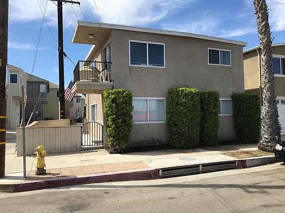 The front of the building. The gate leads to the designated patio for apartment #1 and the lower level windows are in the kitchen and front bedroom of the apartment.