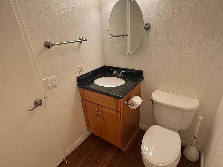 Convenient main-floor half bath/powder room featuring elegant granite countertops