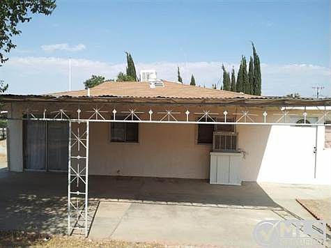 West side of building; Sliding Glass door leads into dining room; Patio/Carport; Evap into Master Bedroom  window and Master exterior access door.