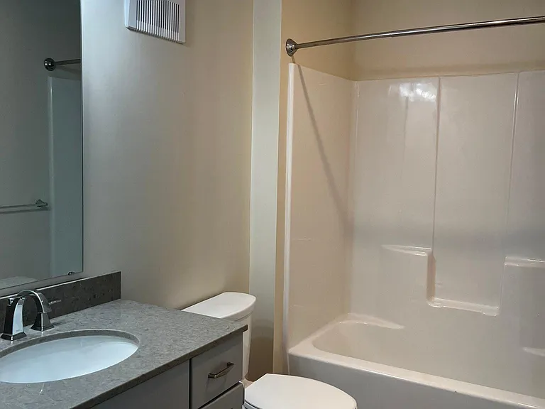 Second Bedroom/Guest Bath with stone countertops and shower/bathtub