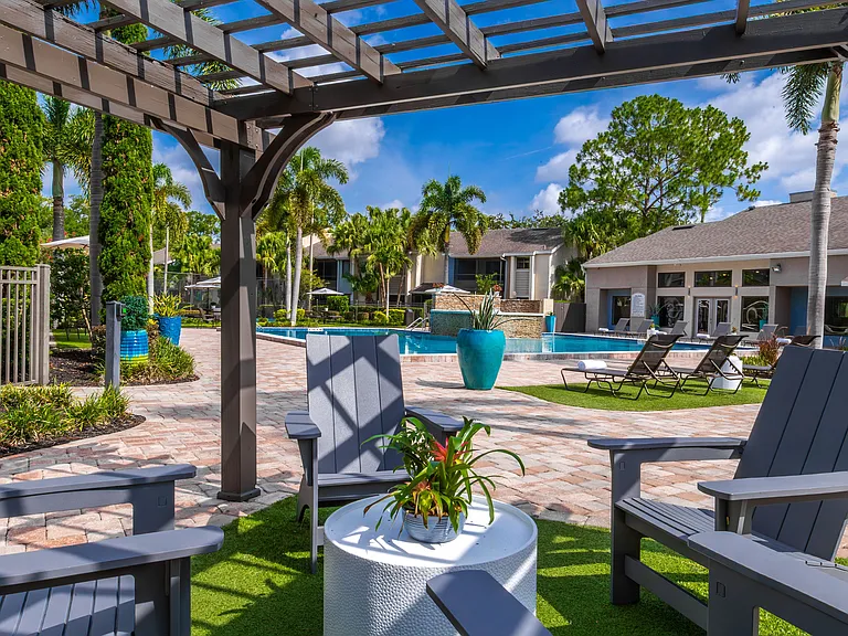 Soak up the resort lifestyle with peaceful poolside seating nestled under a shaded pergola and surrounded by tropical landscaping.