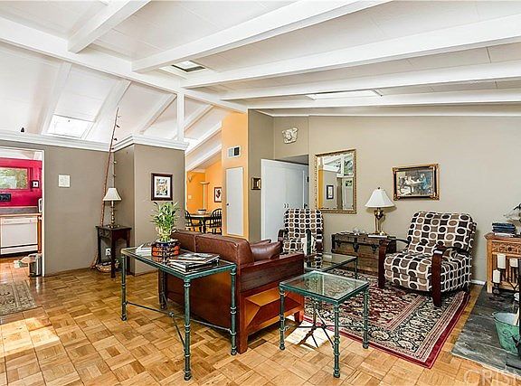 Living room has 3 skylights, giving home a warm, l