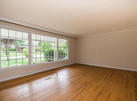 Sunny living room has large windows