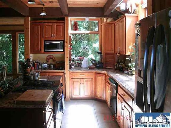 Floor to nearly ceiling bookshelves reach all the way to where the loft begins. 
