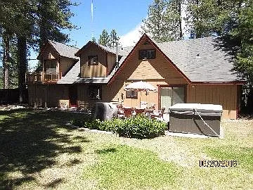 back of house with hot tub