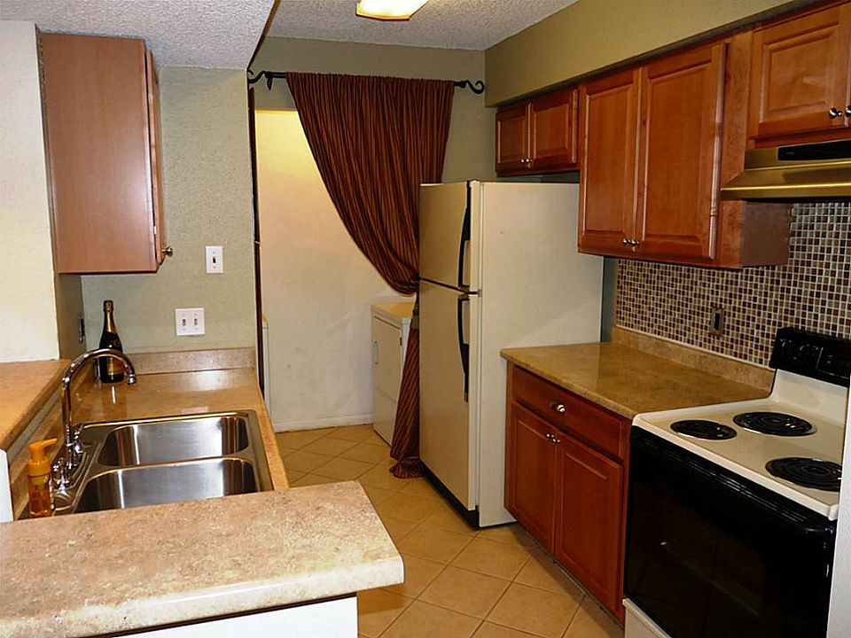Updated kitchen with recent counters, glass tile backsplash, wood cabinets, tile floors. All appliances, washer, dryer, & refrigerator, are included.