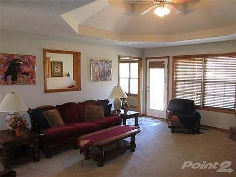 The spacious Living Room opens to the Kitchen/Dining combination with door access to the Patio outside.