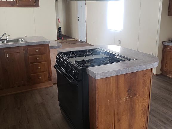Gas range and range hood in center of kitchen