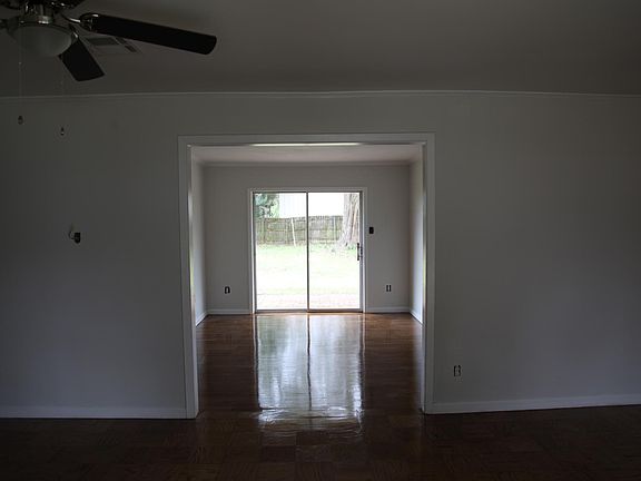 Extra large living room that enters into the dining room, both overlooking big back yard with privacy fence and brick patio. Open floor plan and professionally refinished original hardwood floors make this home come to life.