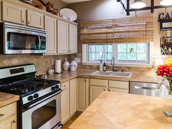 Great kitchen with wood flooring, travertine counter tops. Very cozy family room right off of the ki