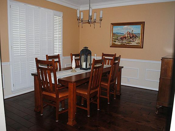Formal dining, as you enter, makes an elegant setting for your guests with its crown molding and woo