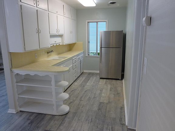 Great working kitchen with bright overhead lighting. Stove and refrigerator provided with the unit.