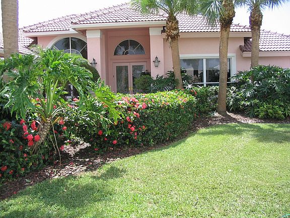 Front yard - plush landscaping with private walkway.