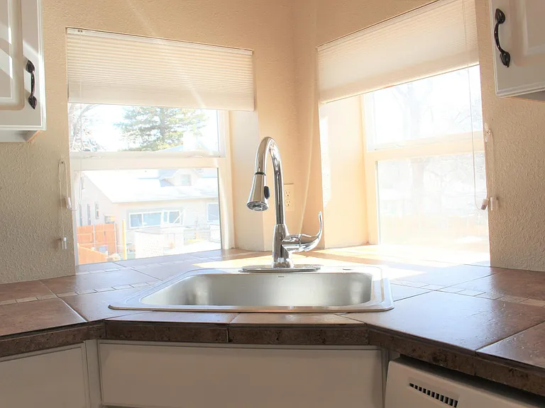 Corner sink with windows for kitchen herbs and natural light