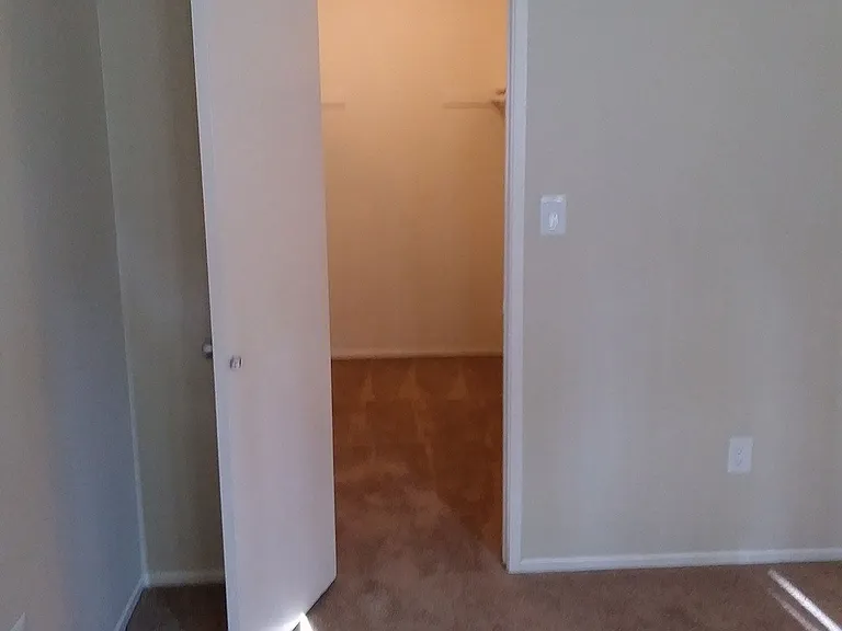 Betroom with large walk-in closet at Teton Pines Apartments in Esoncdido, California.
