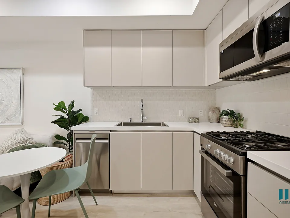 Open-Concept Kitchen with Stainless-Steel Appliances and Ample Cabinet Storage