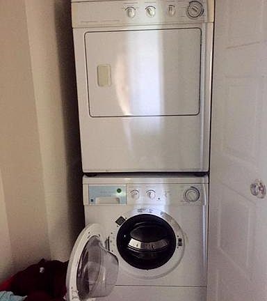 Stacked washer/dryer in unit