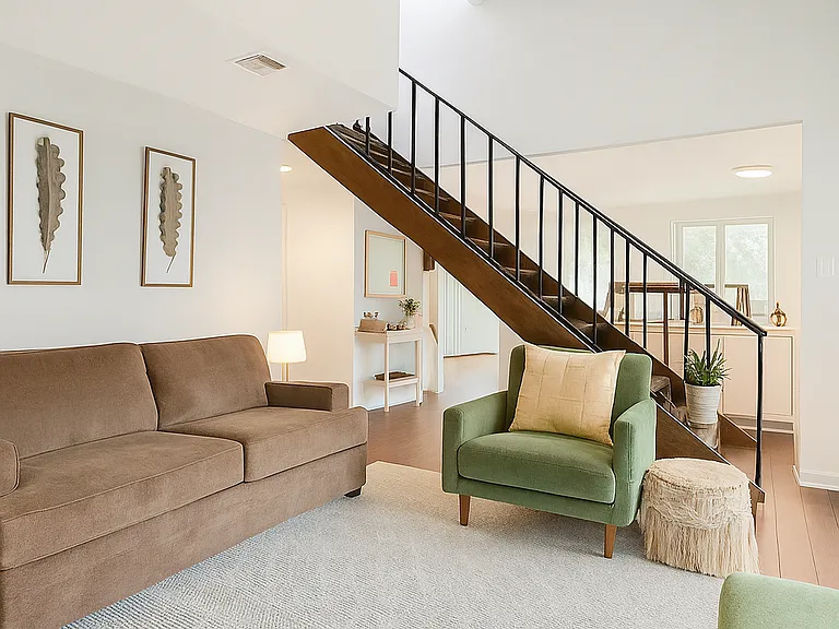 This inviting living space combines cozy seating with a light-filled layout, offering the perfect setting to relax or connect with friends.
