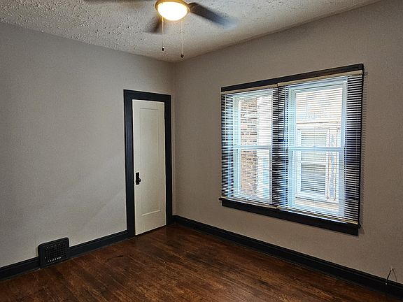 Freshly painted bedroom #1 with new fan and new blinds.
