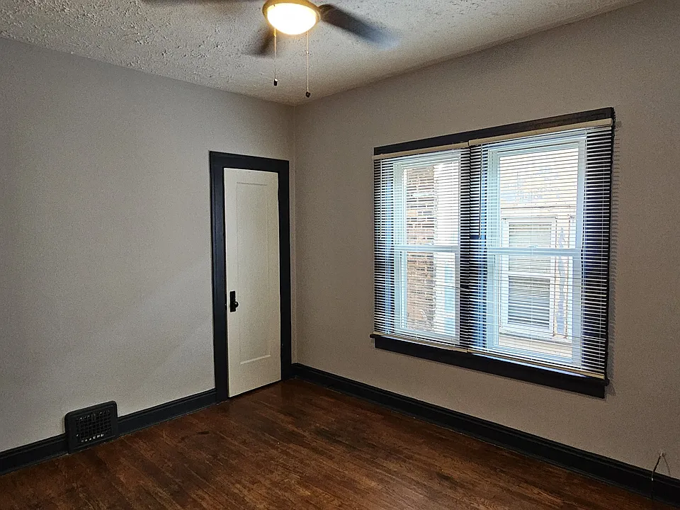 Freshly painted bedroom #1 with new fan and new blinds.