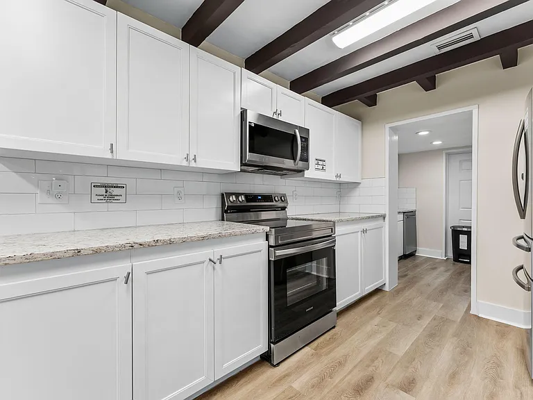 Updated kitchen with shaker cabinetry, ample counter space, and stainless-steel appliances for convenient everyday cooking.