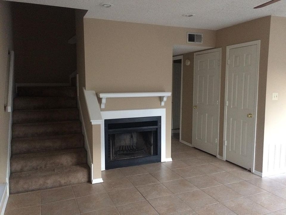 Living room has a wood burning fireplace.