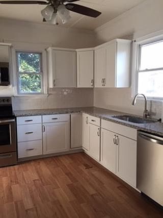 Updated kitchen with granite countertops and all stainless steel appliances and farmer's sink.