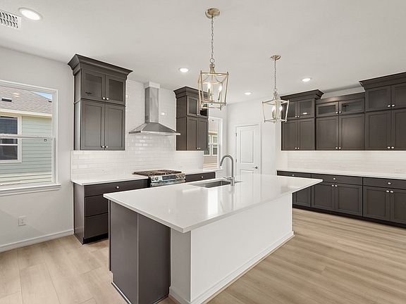 Kitchen with brushed nickel pendant lighting