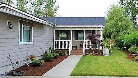 The house from the approaching long driveway. Garage is on the left.