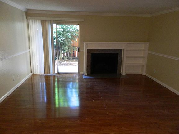 Downstairs Apts only feature beautiful laminate floors throughout & fireplace with built in bookshelf. Upstair's Apts have carpet throughout NOT hardwood floors.
