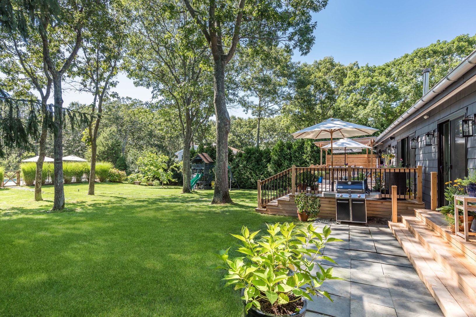 yard and side patio in front of guest bedrooms