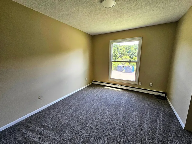 bedroom with large window and natural lighting