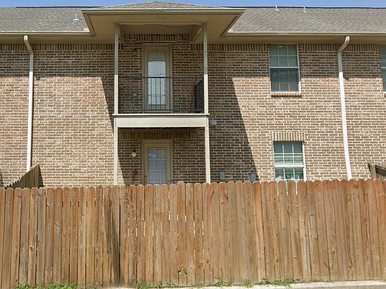 A back Patio and beneath it a fenced in private backyard.