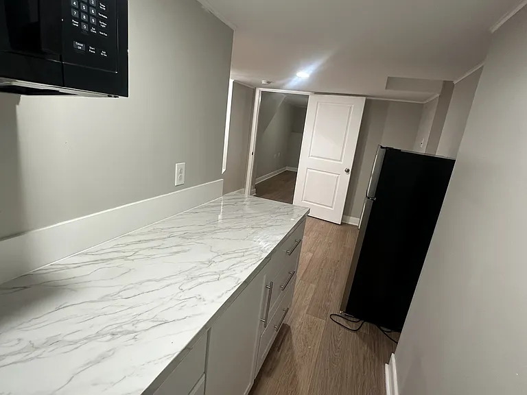 Basement Kitchenette (Microwave, Small Fridge, & Plug-In Outlets)