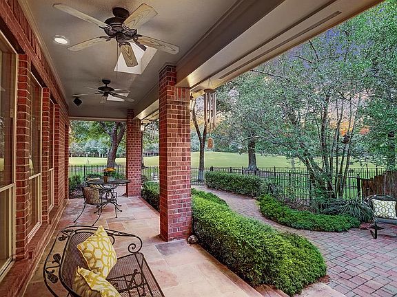 The inviting covered porch and expansive patio overlook the beautiful 10th hole of the Panther Trails Course.