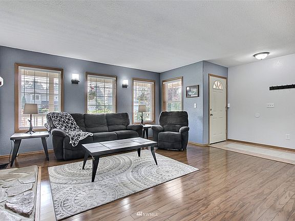 As you enter you will find great flooring throughout the home, lots of windows and a great stone fireplace in the family room. 