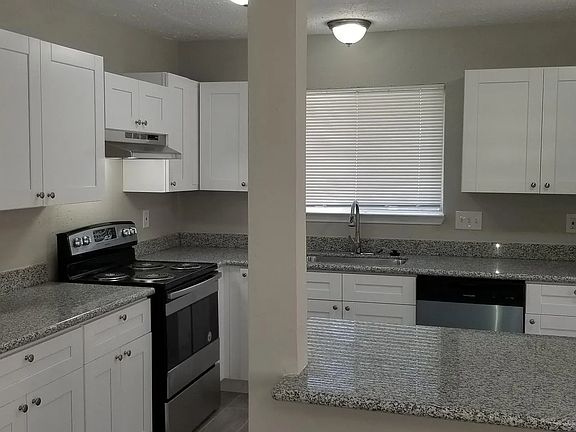 This kitchen was designed for entertaining with ample storage, counter space, stainless steel appliances (included), granite countertops, and popular white shaker cabinets. The kitchen opens into the dining area that fits a 6-8 person table.
