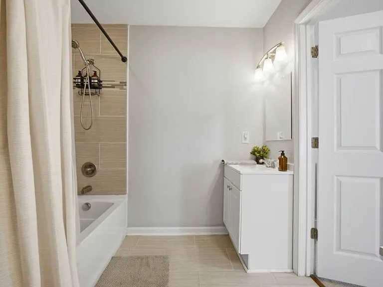 Primary en-suite bathroom with 2 vanity sinks.