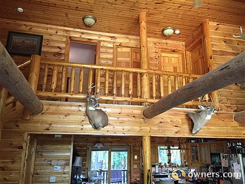 Living area with vaulted ceilings and overlooking loft