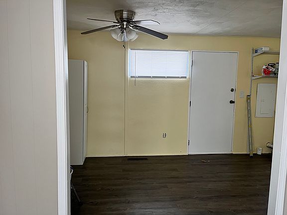 From living room facing dining area. Ceiling fan to help keep your kitchen cool in the summer. Small pantry comes with the home.