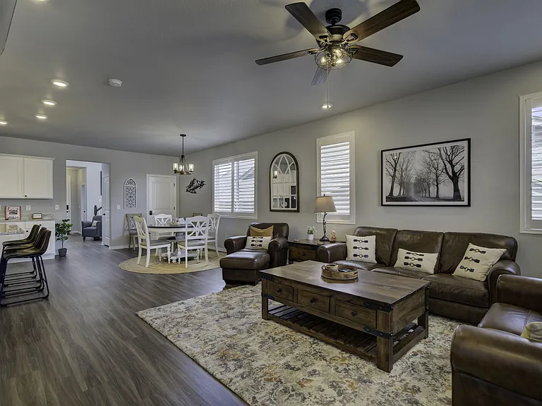 Living room with cozy leather couches and armchair around a gas fireplace and large smart TV - stay in and relax!