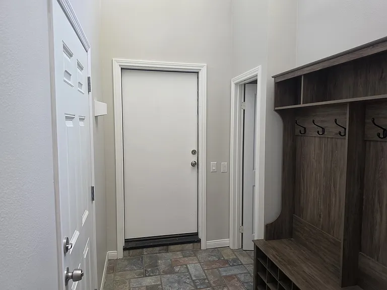 Entrance foyer with front door and door to garage.