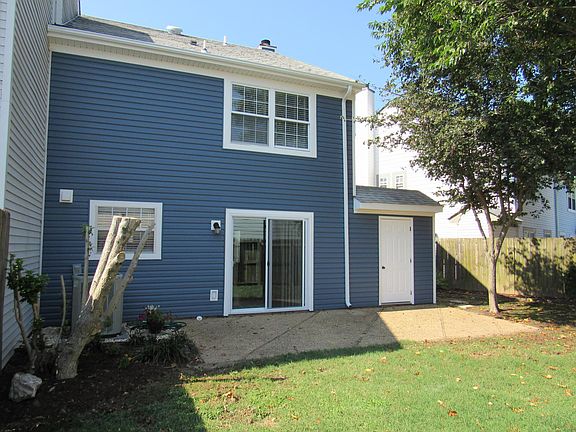 Patio with fenced in backyard.