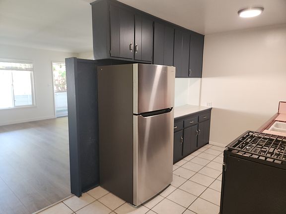 Kitchen with new stainless refrigerator