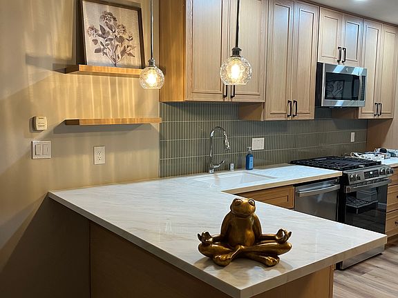 Custom design kitchen with island. Plenty of counter top and storage to prepare meals.
