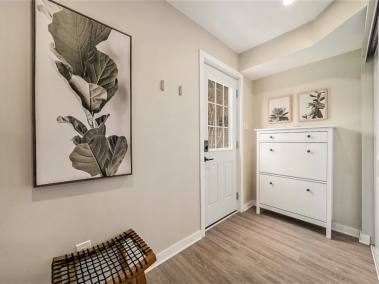 Welcoming entryway featuring minimalist decor and convenient storage in our Ottawa rental.