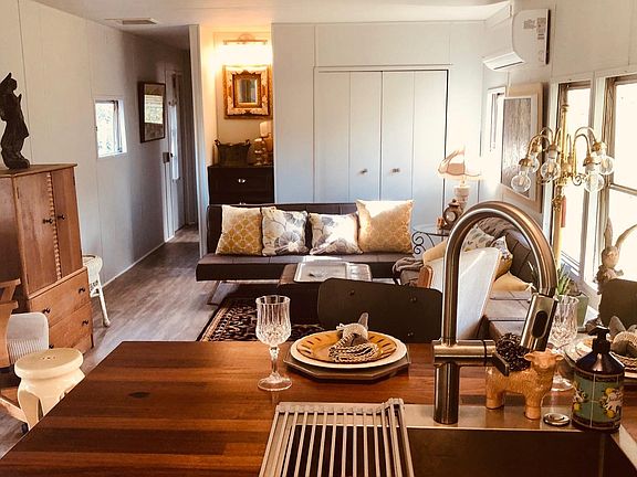 Open concept. View from kitchen into living area. Fully furnished. New futons & barstools. New kitchen sink and garbage disposal. Charming butcher block countertops throughout kitchen. pic yr 2020